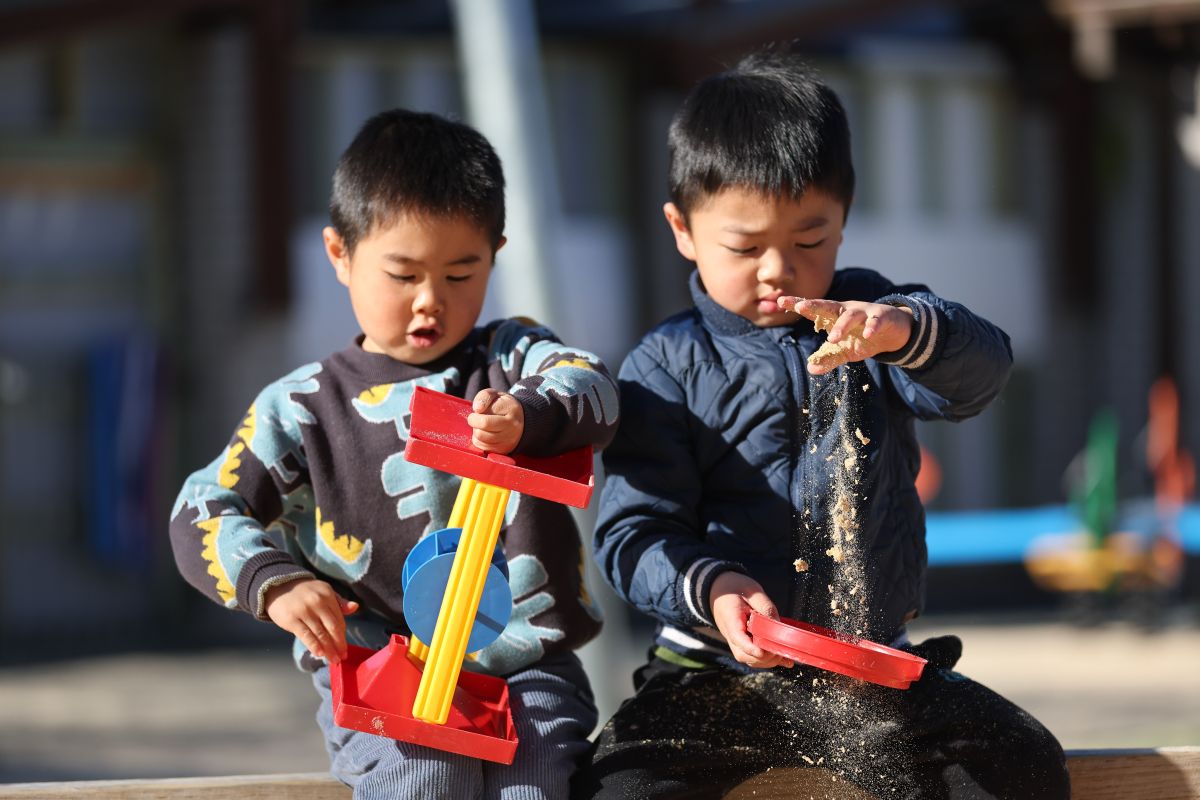 Students playing in the sandpit